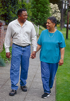 Man and woman walking outdoors.