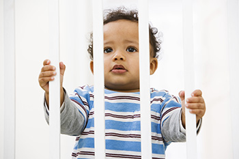 Child looking through baby gate