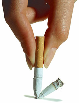 Close up view of a woman's hand putting out a cigarette.