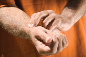 Closeup of pads of first two fingers on inner wrist of opposite hand, just below thumb.