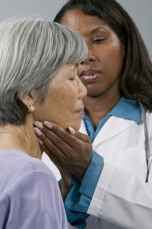 Doctor examining patient's neck.
