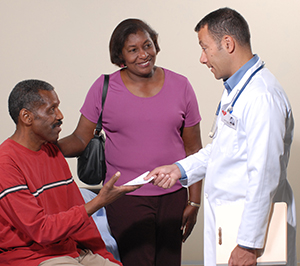 Doctor talking to patient and caregiver.