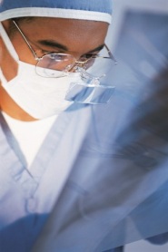 Doctor wearing a surgical mask looking at a chest X-ray