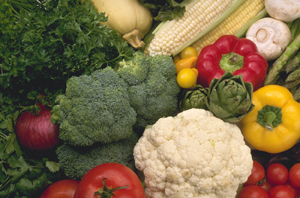 Fresh vegetables, including broccoli, cauliflower, squash, and tomatoes.