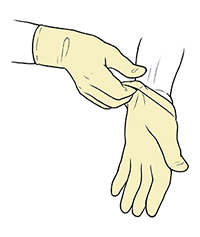 Gloved hand pulling sterile glove up to wrist of opposite hand.