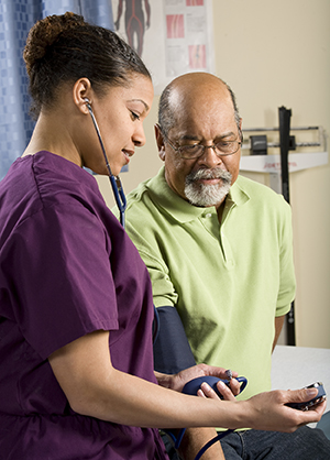 Healthcare provider taking man's blood pressure.