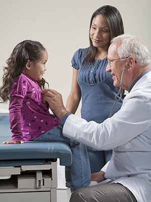Healthcare provider talking with a girl and her mother.