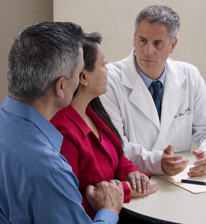  A man and woman discussing treatment plan with a healthcare provider.