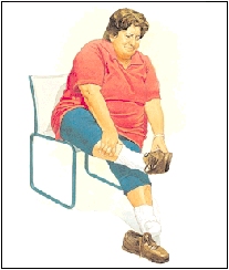 Woman sitting in a chair holding foot