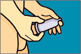 Image of a teen squeezing the air out of the condom's tip.