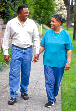 Man and woman outdoors, walking.