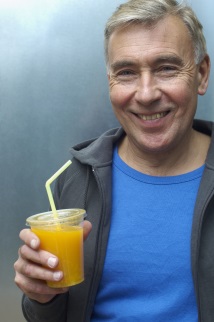 Man holding cup of orange juice