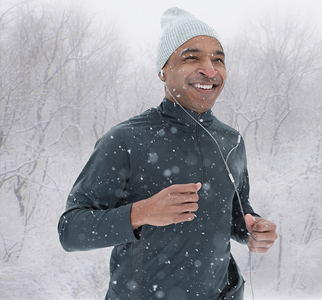 Man jogging with snow falling