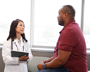 Man talking to health care provider.