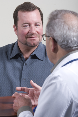 Man talking with doctor.