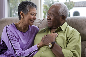 Older couple sitting on couch.