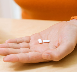 Person's palm, with several pills in it