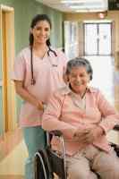 Photo of a health care professional with an older woman in a wheelchair
