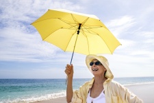 Photo of woman at the beach demonstrating sun protection strategies