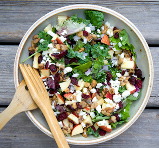 Salad in large bowl with serving utensils