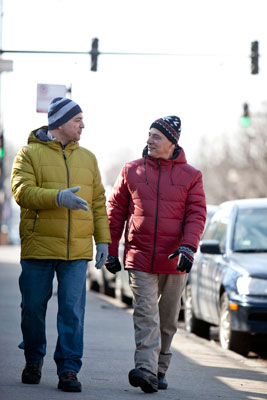 Two men walking down the street in winter