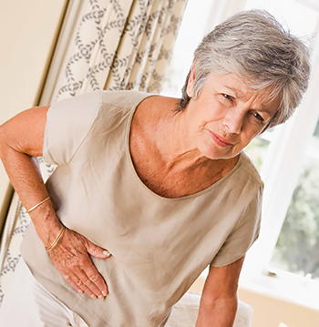 Woman bending over in pain