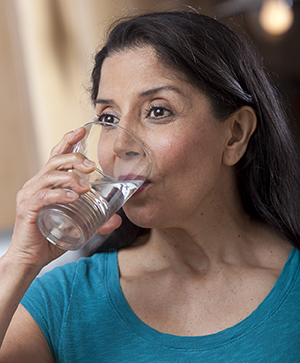 Woman drinking glass of water.