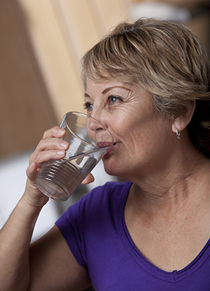 Woman drinking glass of water.