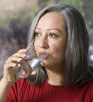 Woman drinking water.