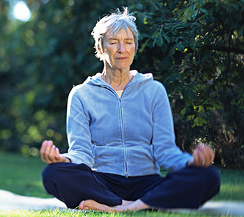 Woman sitting in lotus yoga pose