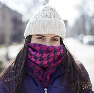 Woman wearing winter scarf over nose and mouth.