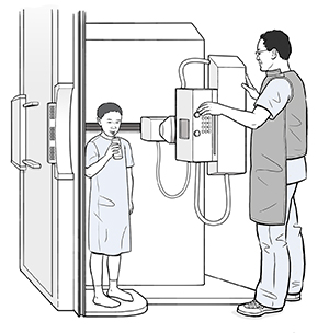 Child standing in  flouroscopy scanner sipping a bottle of liquid through a straw while a healthcare provider adjusts the machine.