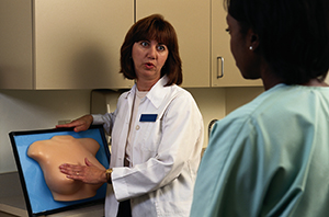Health care provider explaining breast self exam.