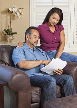 Middle age couple looking at papers.