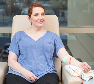 Technician taking blood donation from man’s arm.