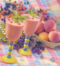 Colorful table setting with two peach melba smoothies