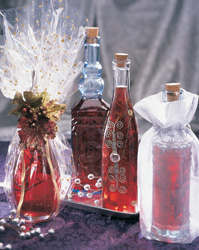 Decorateive bottles of red rosemary vinegar some wrapped in gift wrap.