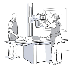 Boy lying on table under an X-ray machine while healthcare providers adjust it